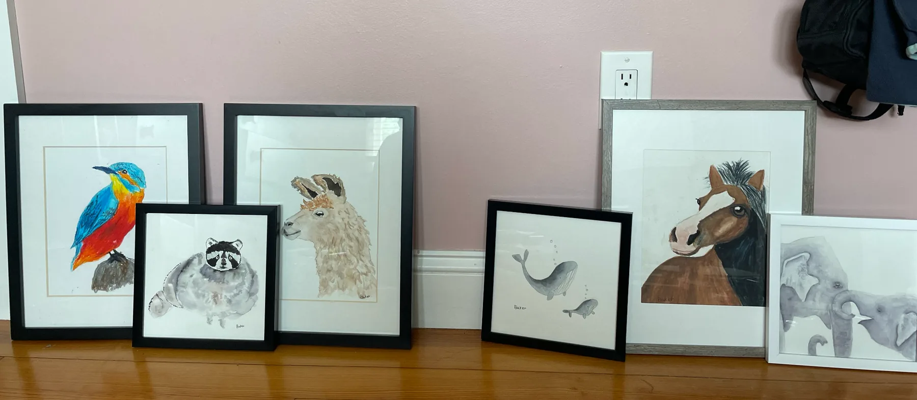 A collection of Baker's framed watercolor artwork